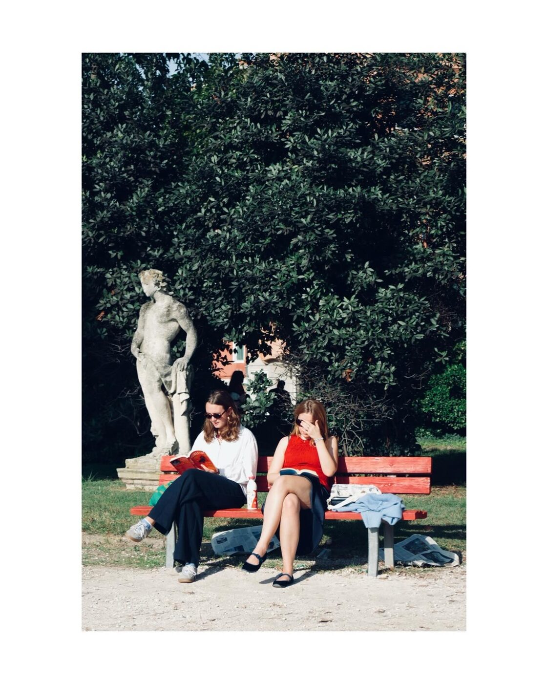 Two women sitting on a park bench